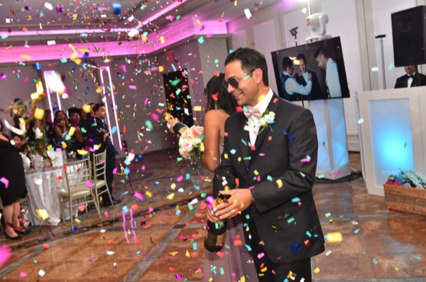 Guest celebrating under a confetti shower on the dance floor